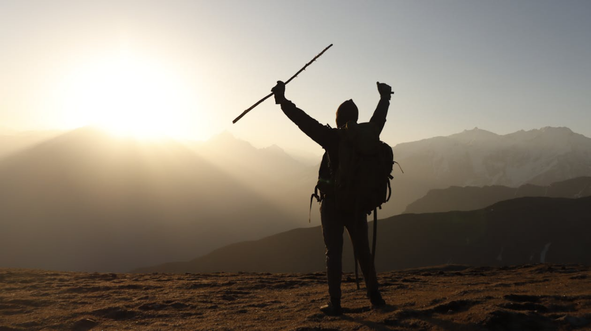 Hiker standing at sunrise showing why meaning matters in life through purpose and resilience.