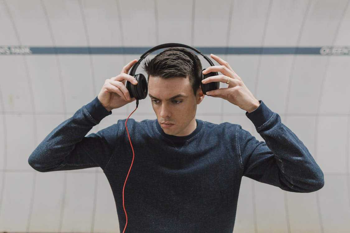 person wearing headphones, illustrating why songs get stuck in your head