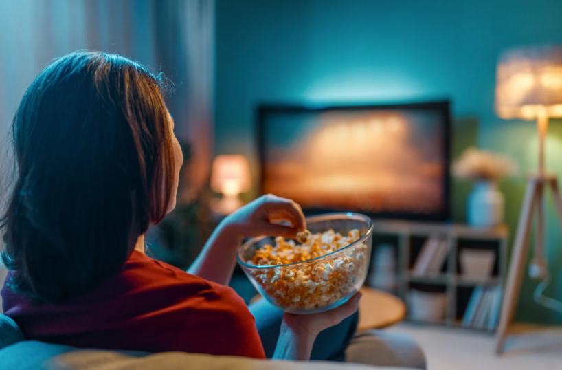 person watching suspenseful content while wondering why we love true crime so much