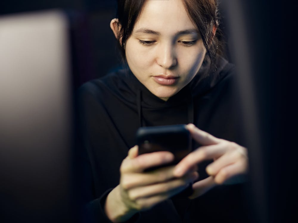 Person scrolling on a phone while learning how to stop comparing yourself to others on social media.