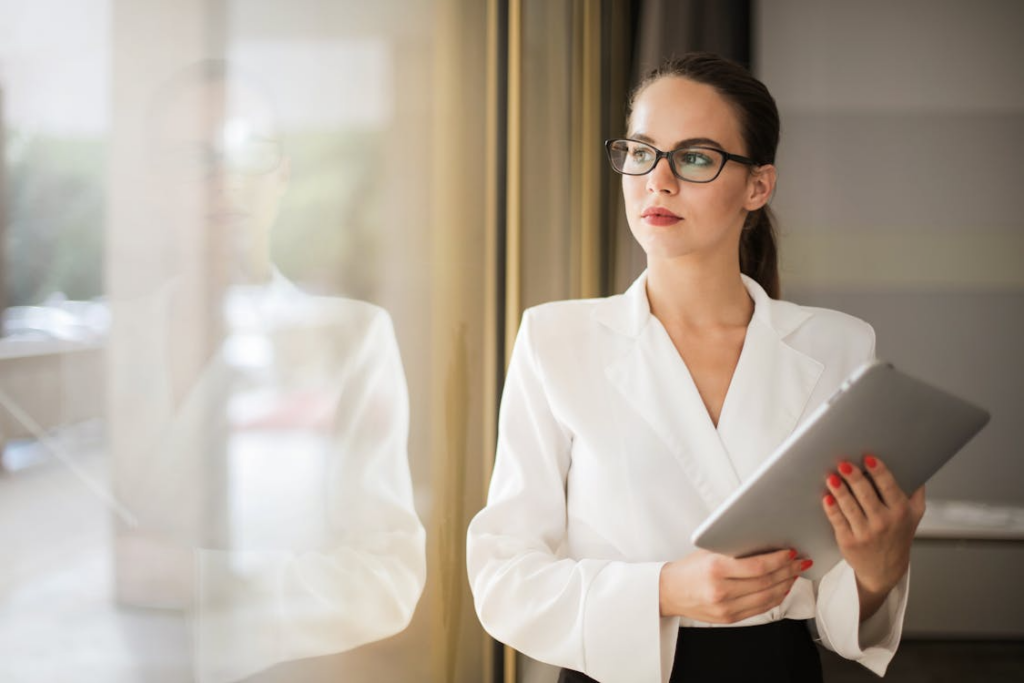 Professional holding a tablet while reflecting on the right career path and future work choices.