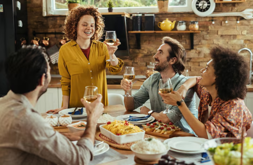 Friends sharing a meal together showing what makes people happy through meaningful relationships.